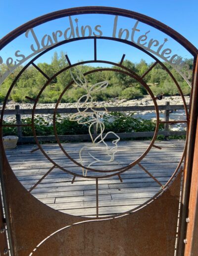Portail circulaire portant l’inscription Les Jardins Intérieurs.